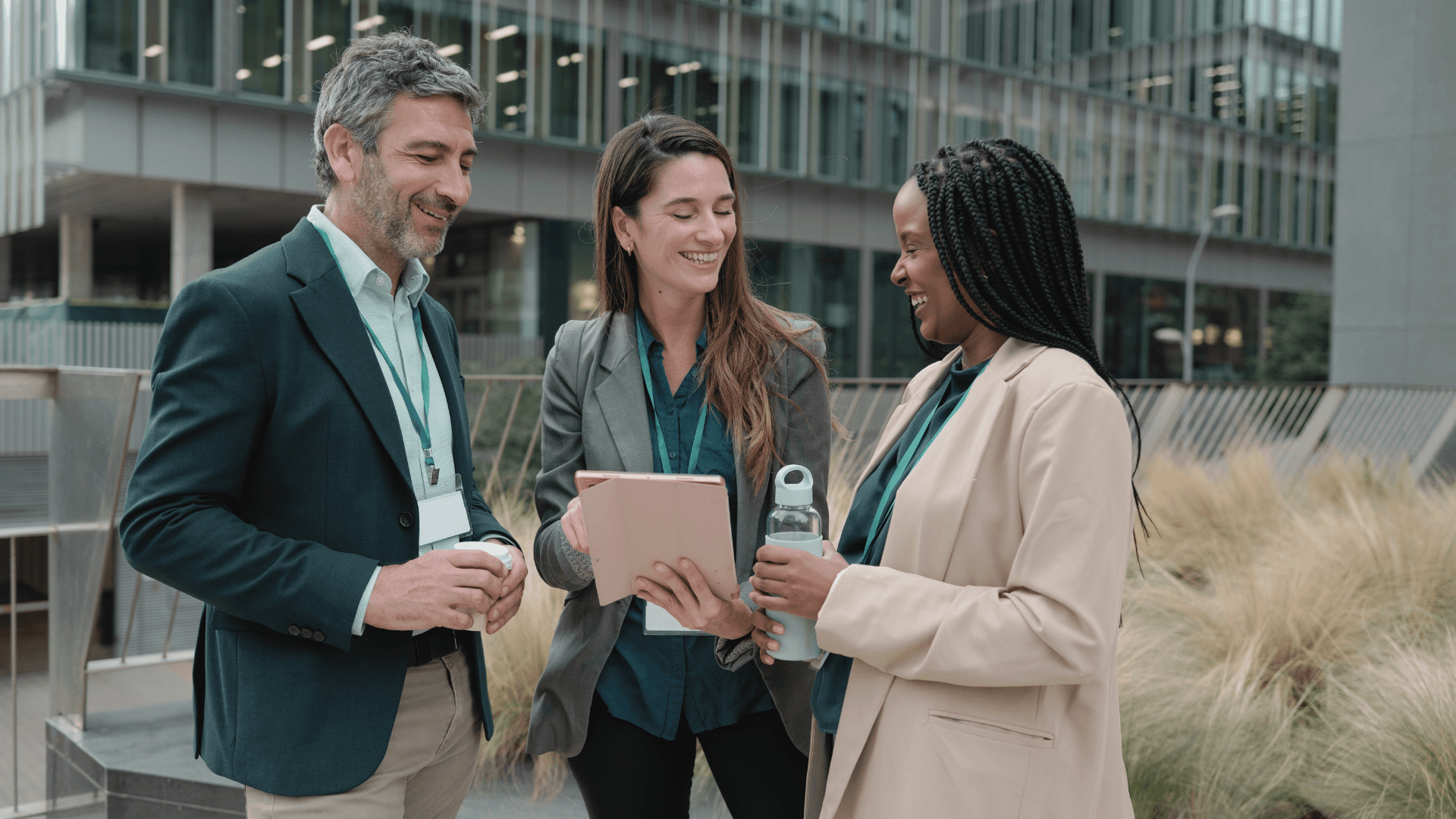 Business team meeting outside a modern office